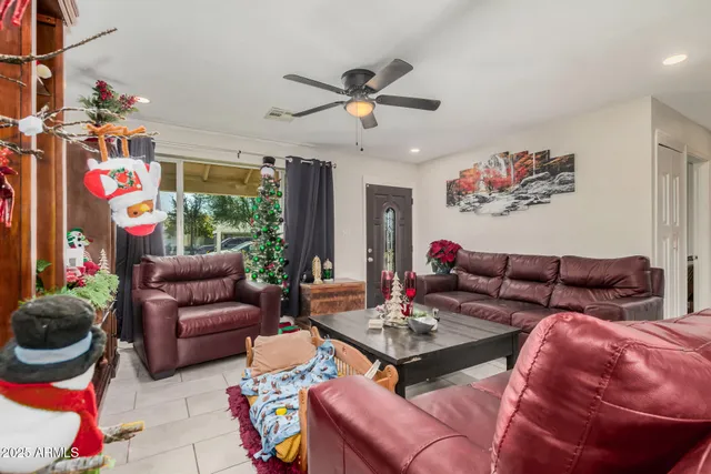 a living room with furniture a rug and a chandelier