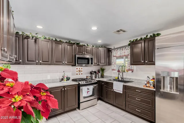 a kitchen with a sink stove and cabinets