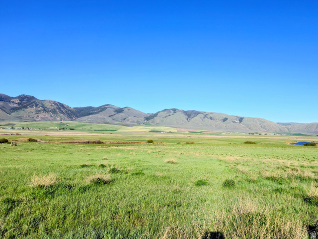 1948 Lower Bern Road, Unit 3 Bern, ID 83220 - Photo 2 of 8 Expansive green acreage featuring distant mountain ranges and a visible pond