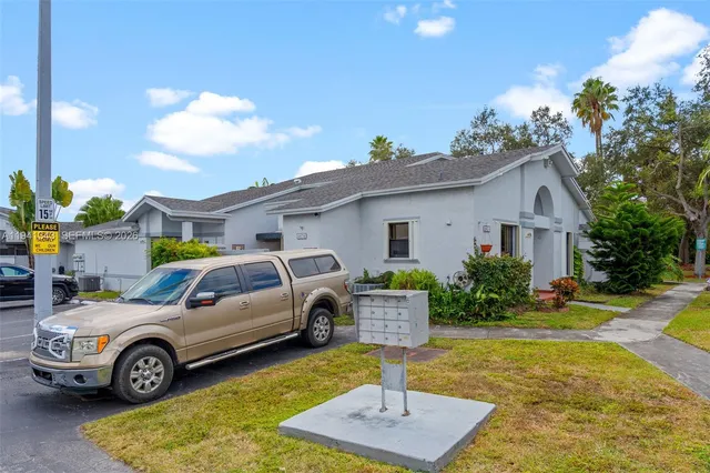 a view of a hallway with wooden cabinets