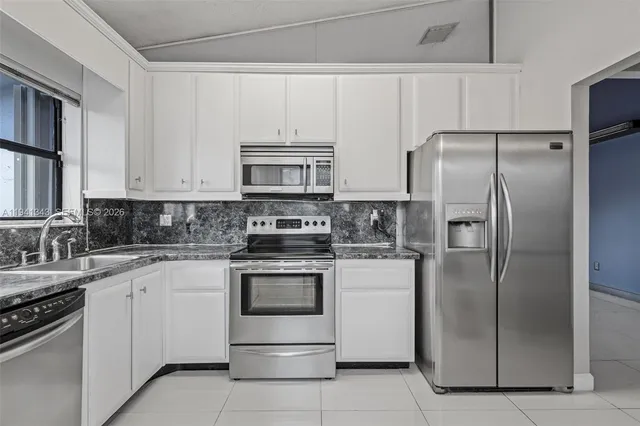 a view of cabinets and a window