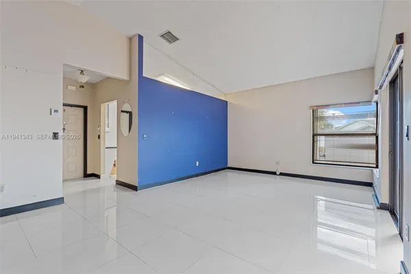 a view of an empty room with a window