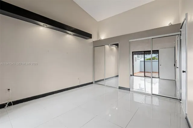 a view of empty room with a view of bathroom