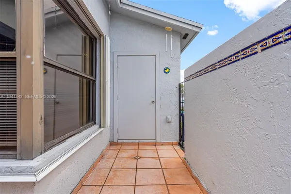 a view of a house with backyard and sitting area