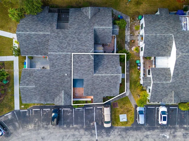 an aerial view of residential houses with outdoor space and swimming pool