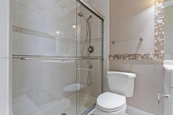 a white toilet next to a bathroom sink