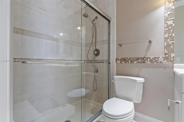 a white toilet next to a bathroom sink