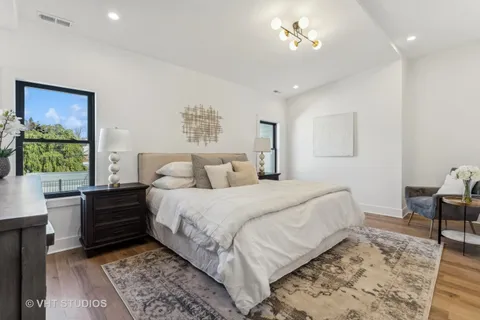 a spacious bedroom with a bed and a window