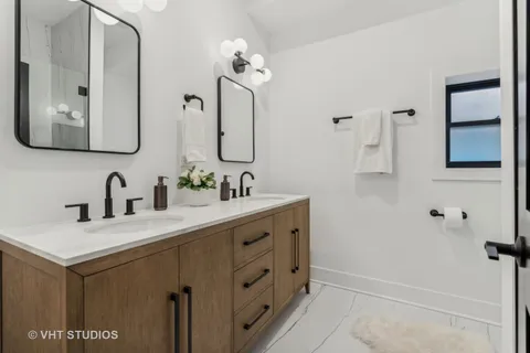 a bathroom with a double vanity sink mirror and