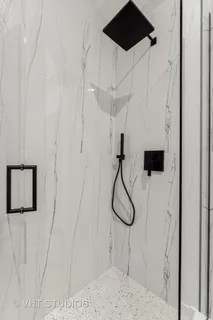 a picture of a room has a glass shower door