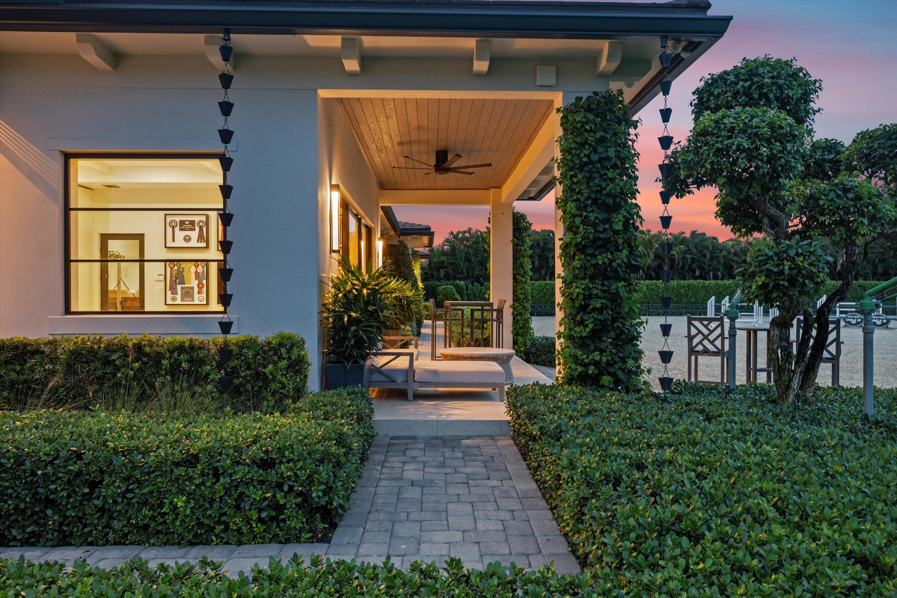 4675 Stables Way Wellington, FL 33414 - Photo 12 of 16 a front view of a house with a yard