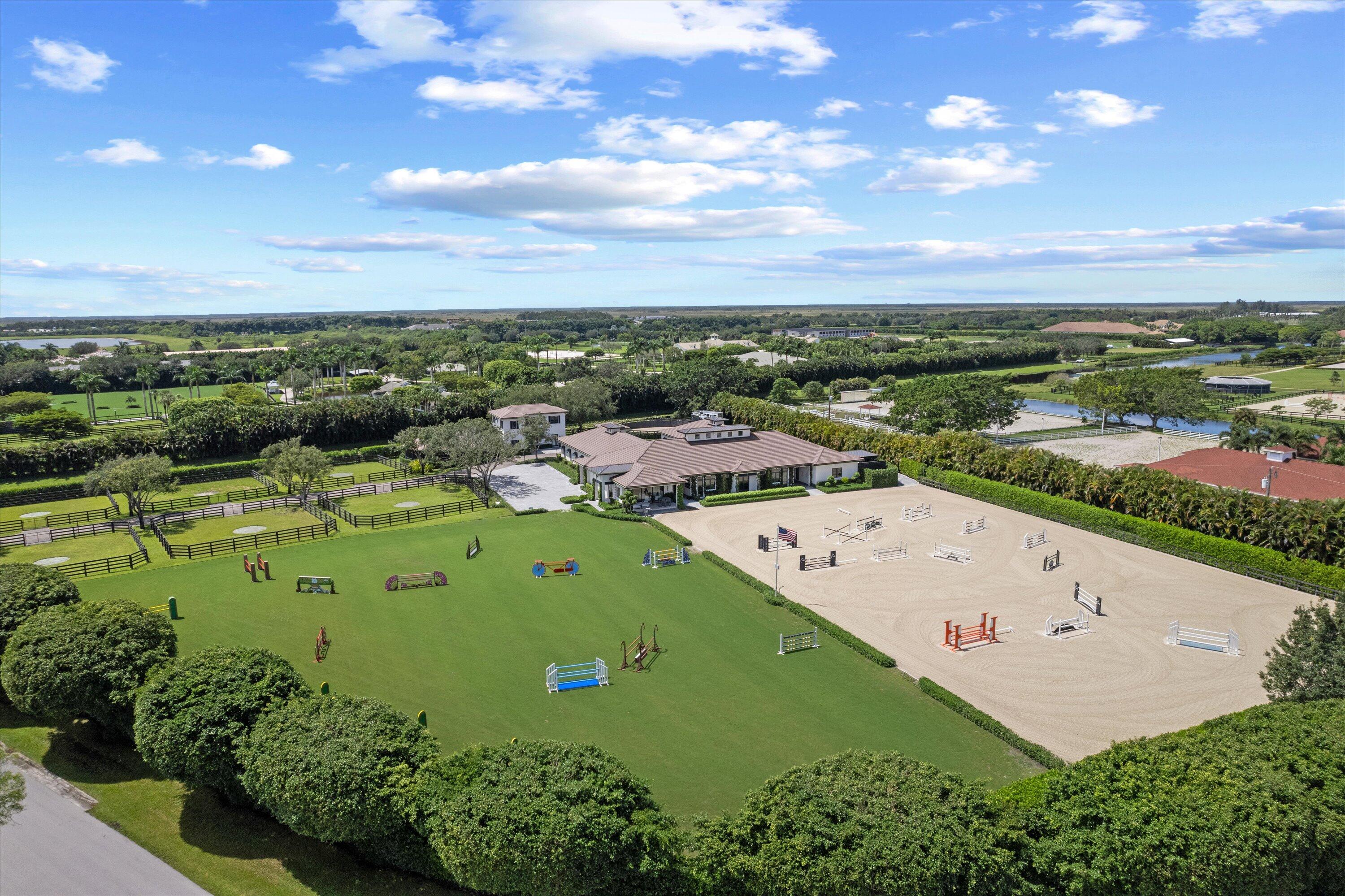 4675 Stables Way Wellington, FL 33414 - Photo 2 of 16 an aerial view of a golf course with parking space