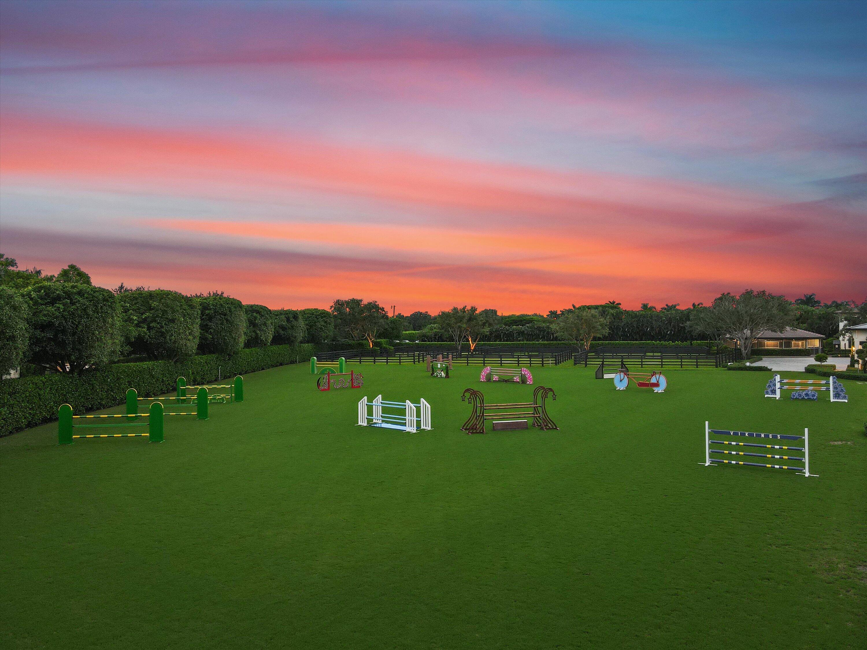 4675 Stables Way Wellington, FL 33414 - Photo 5 of 16 a view of a golf course with a lake