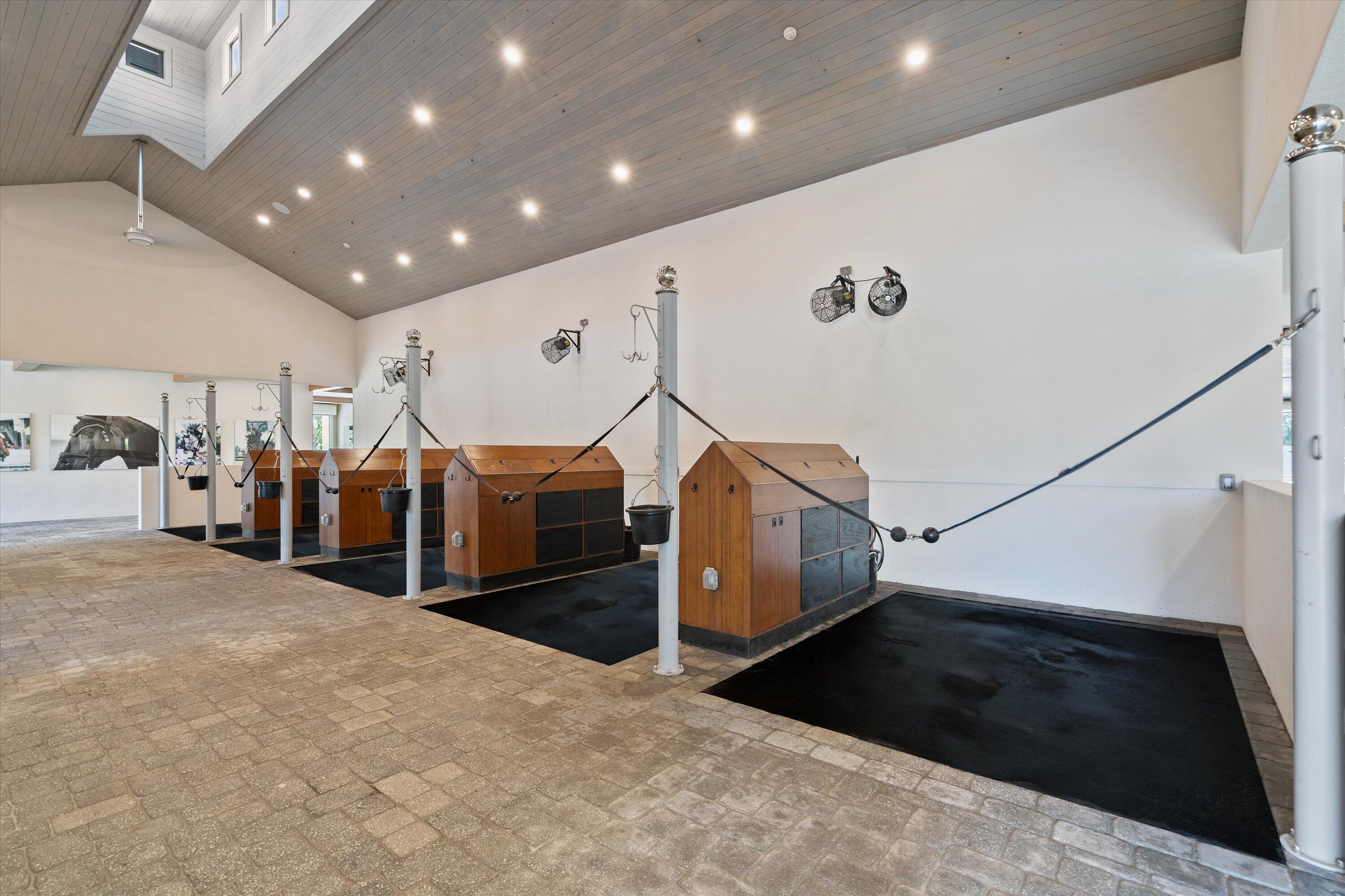 4675 Stables Way Wellington, FL 33414 - Photo 9 of 16 a view of a hallway with lots of gym equipment