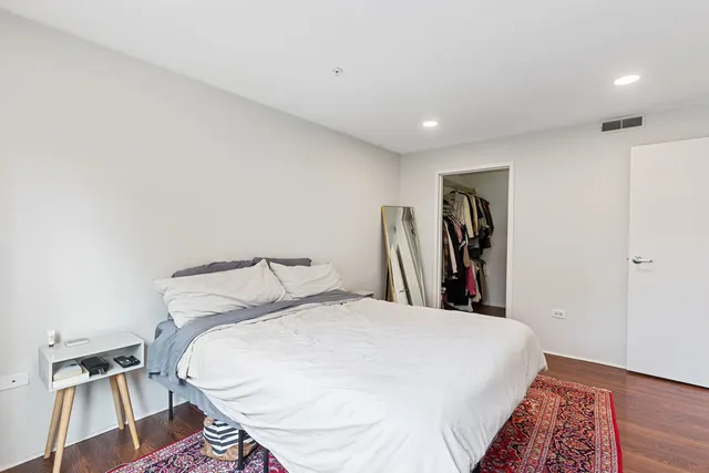 a bed room with a bed and a chair