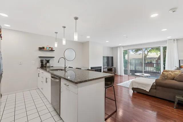 a kitchen with stainless steel appliances granite countertop a sink stove and wooden floor