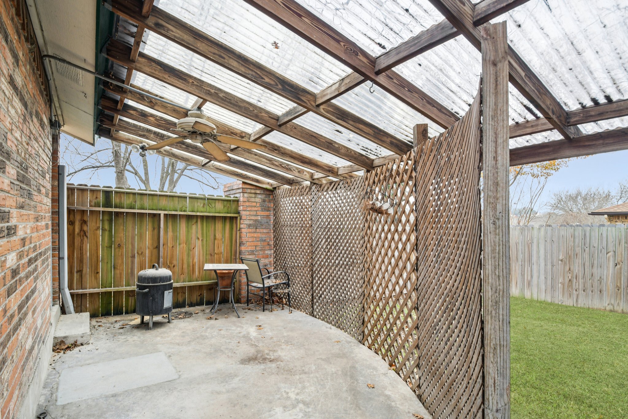 102 Stubblefield Drive Elgin, TX 78621 - Photo 32 of 39 Covered side patio with virtual green grass