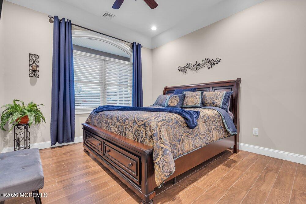 224 Grawtown Road Jackson, NJ 08527 - Photo 22 of 33 a bed sitting in a bedroom next to a window