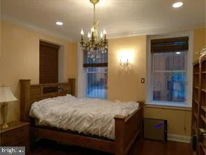 a bedroom with a bed and a chandelier