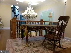 a view of a dining room with furniture and chandelier