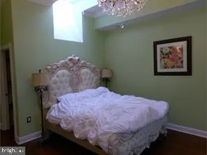 a bedroom with a bed and a chandelier