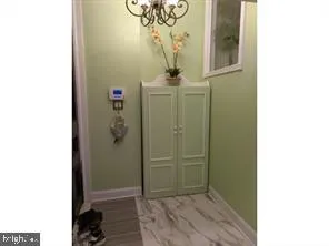 a view of a hallway with wooden floor and entryway