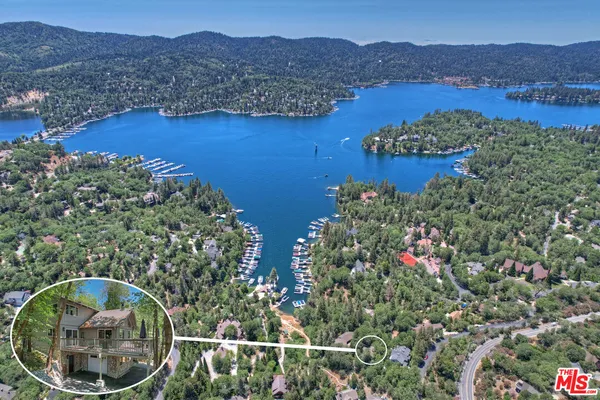 an aerial view of house swimming pool and mountains
