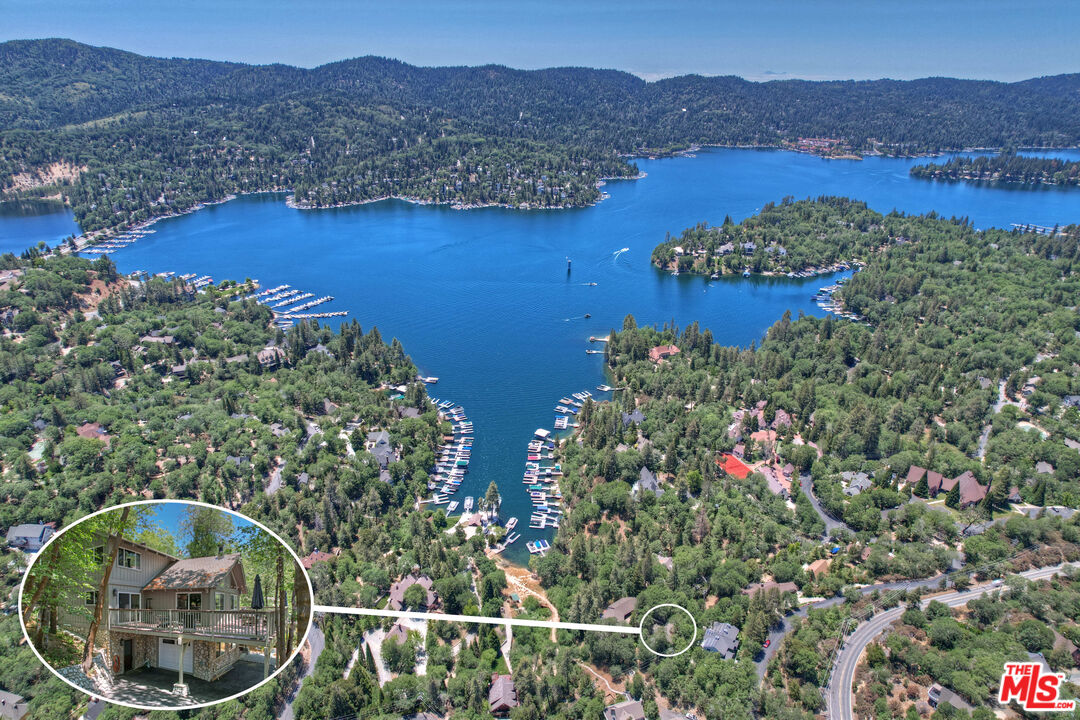 an aerial view of house swimming pool and mountains
