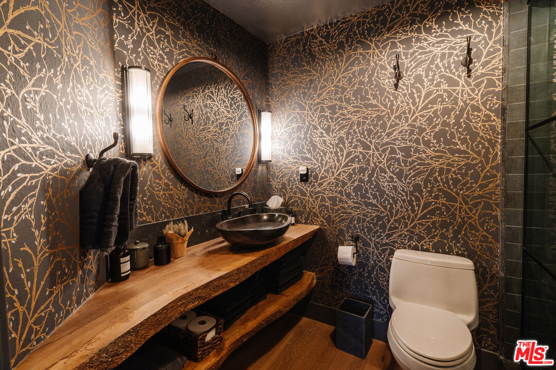 28805 North Shore Road Lake Arrowhead, CA 92352 - Photo 15 of 40 a bathroom with a toilet sink vanity and mirror