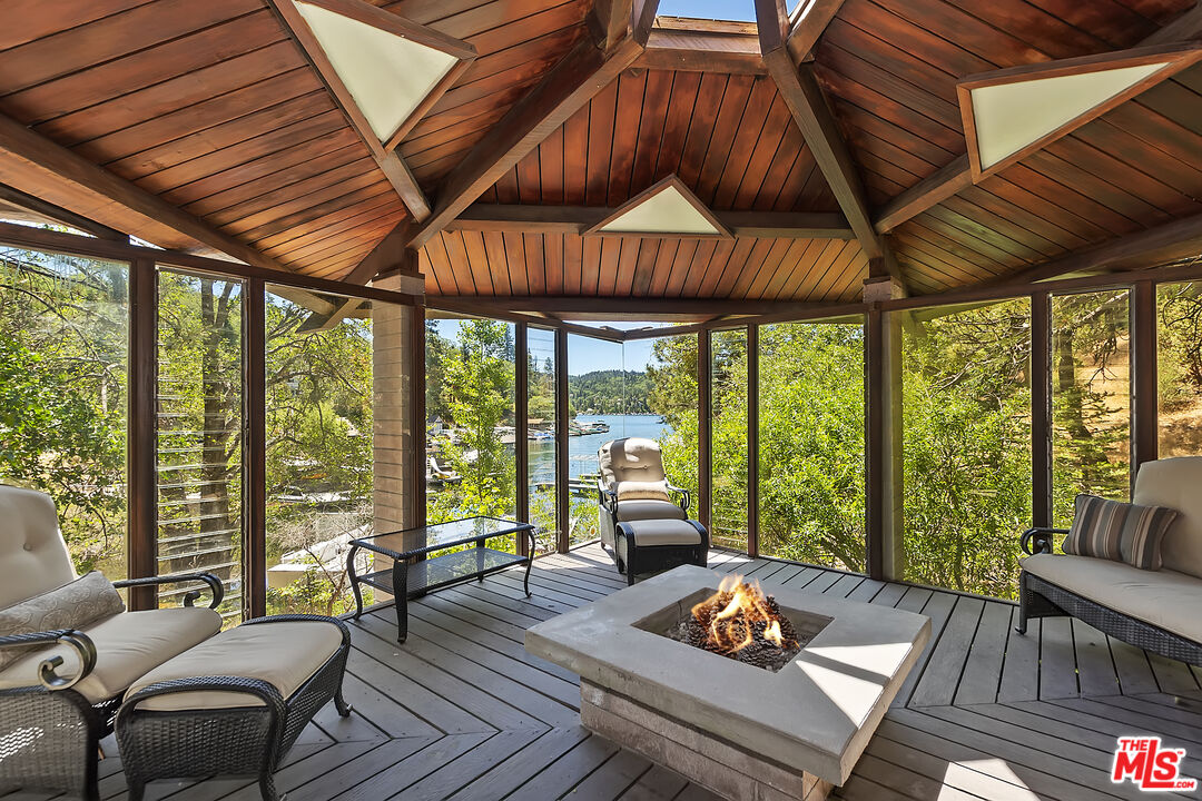 28805 North Shore Road Lake Arrowhead, CA 92352 - Photo 36 of 40 a living room with furniture and floor to ceiling windows