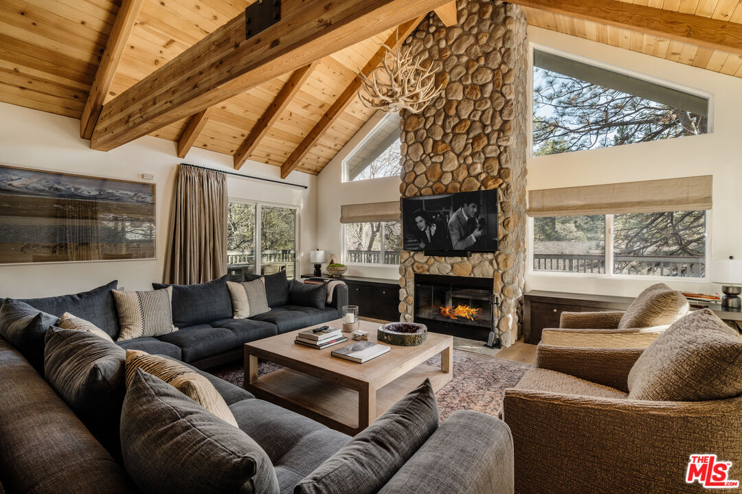 28805 North Shore Road Lake Arrowhead, CA 92352 - Photo 6 of 40 a living room with furniture fireplace and a large window