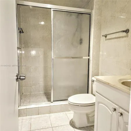a bathroom with a shower a toilet and a sink