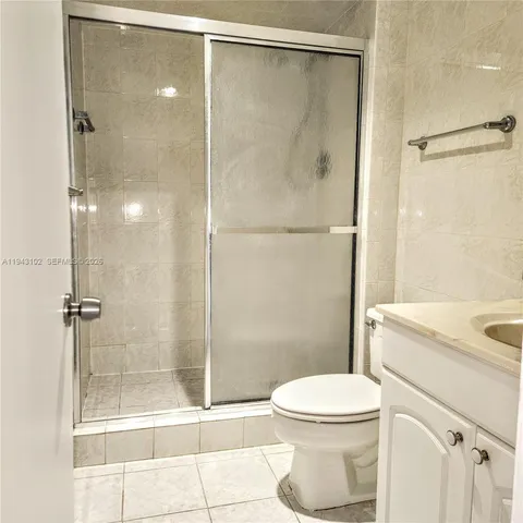 a bathroom with a shower a toilet and a sink