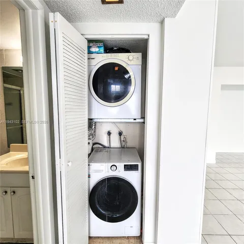 a view of a hallway with washer and dryer