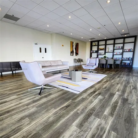 a lobby with furniture and a floor to ceiling window