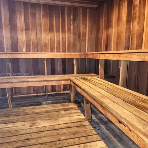 a view of a street with cars and palm trees