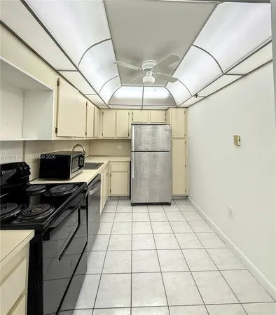 a kitchen with a cabinets and steel appliances