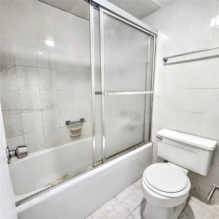 a bathroom with a toilet and a bathtub