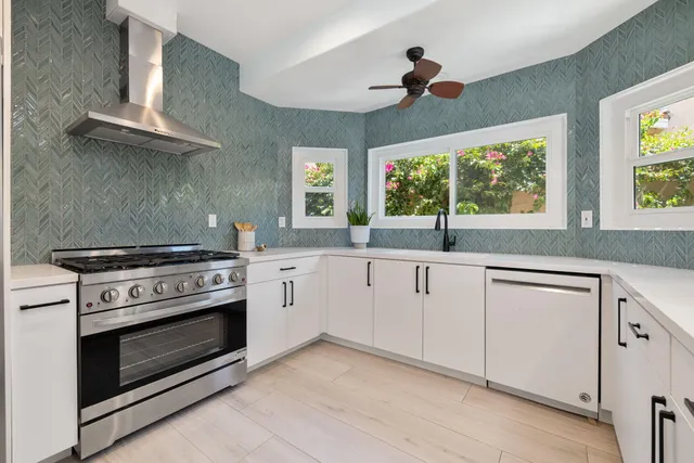 a kitchen with a stove oven and a sink