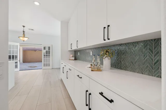 a kitchen with stainless steel appliances a sink stove and cabinets