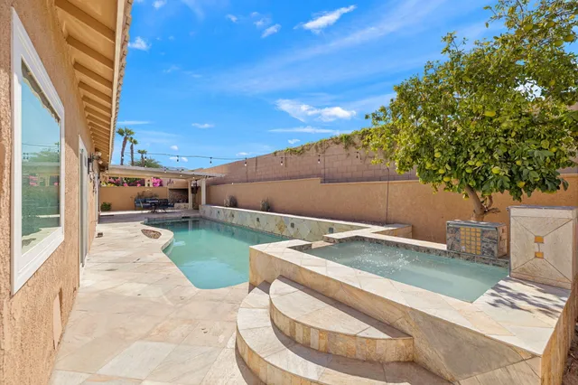 a view of a patio with a dining table and chairs
