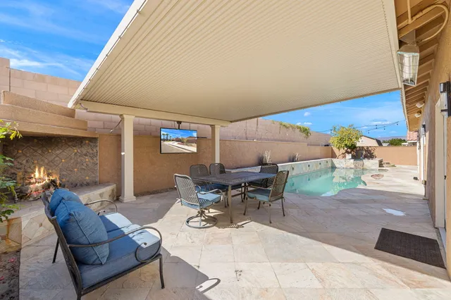 a view of a dining room with furniture and a kitchen view