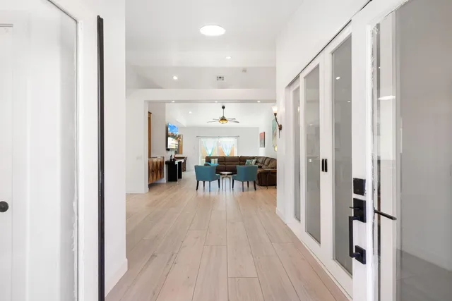 a view of a living room with a table and chairs