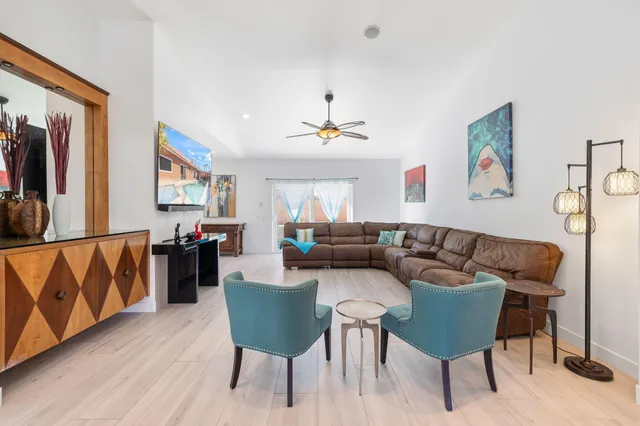 a living room with furniture and a wooden floor