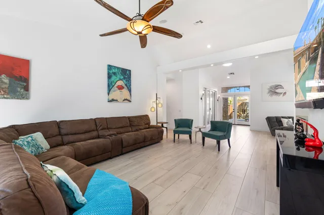 a living room with furniture and a wooden floor