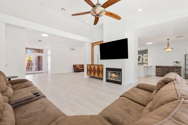 a living room with furniture a fireplace and a flat screen tv