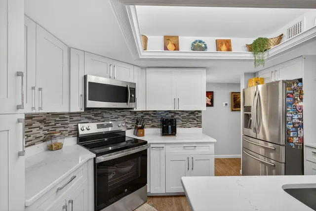 a bedroom with a bed lamp and a potted plant