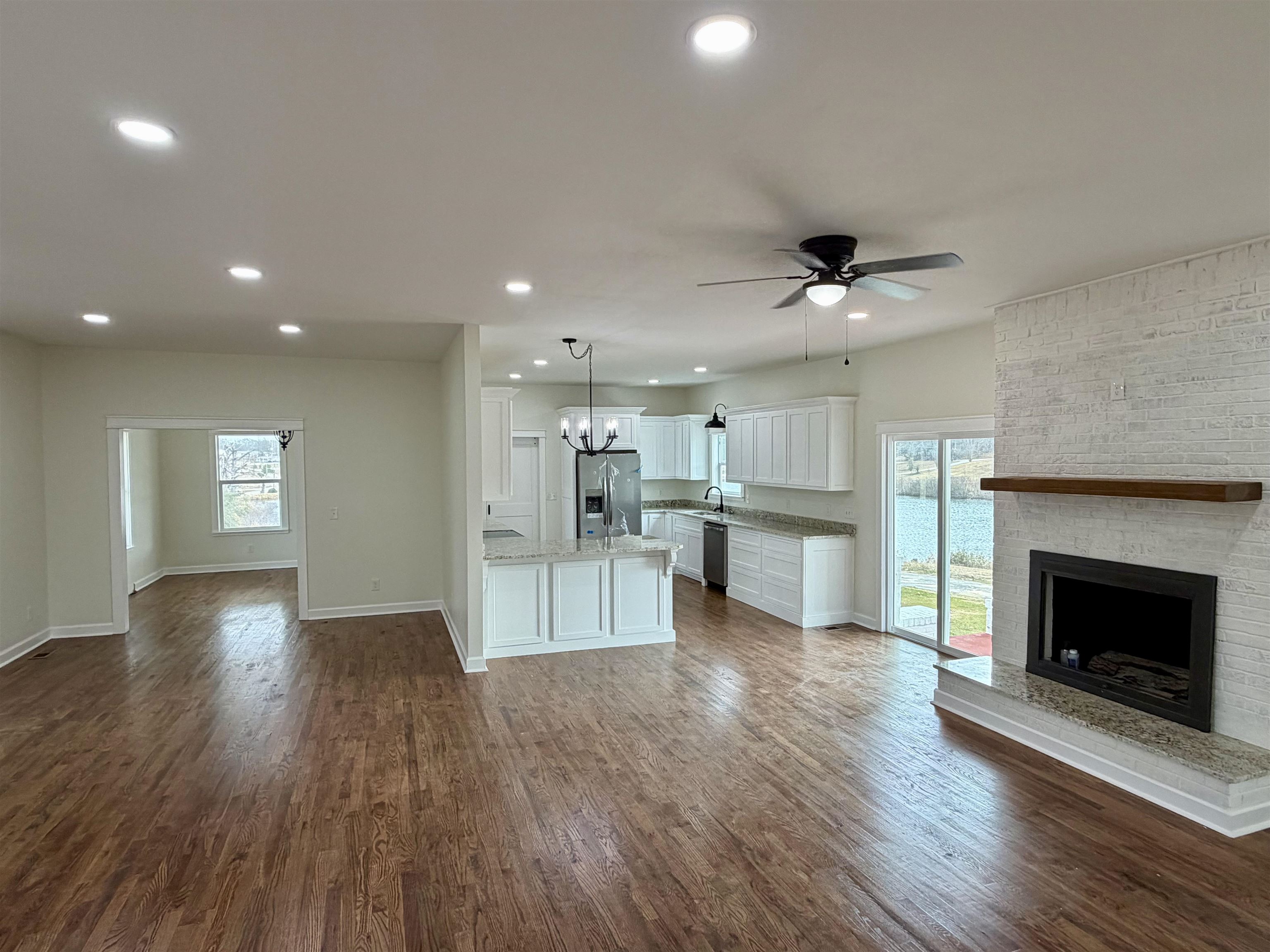 172 New Bethel Road Selmer, TN 38375 - Photo 8 of 30 a view of an empty room with wooden floor and a fireplace