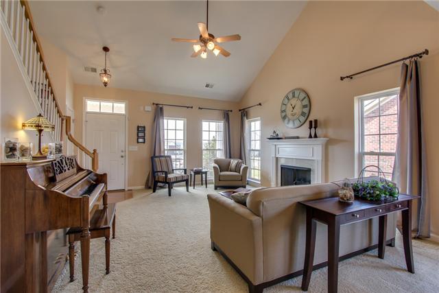 3003 Hope Circle Spring Hill, TN 37174 - Photo 4 of 20 Spacious 18x15 living room features 2-story ceiling, gas log FIREPLACE, upgraded lighting, and TRANSOM front door.