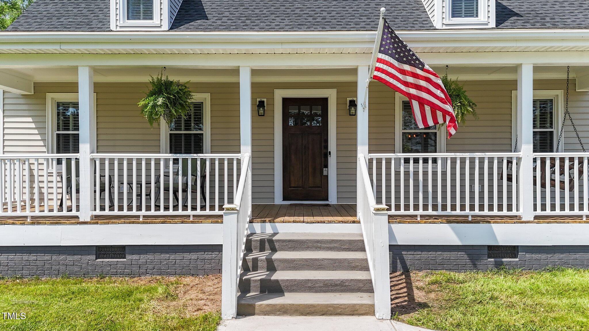 8700 Crowder Road Raleigh, NC 27603 - Photo 3 of 36 a front view of a house with a porch